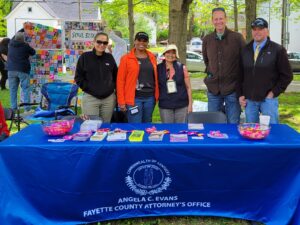 Fayette County Attorney Angela C. Evans and office staff participating in the annual Peace Walk event with a branded resource table.