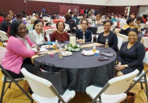 Angela C. Evans with guests at a community banquet event.